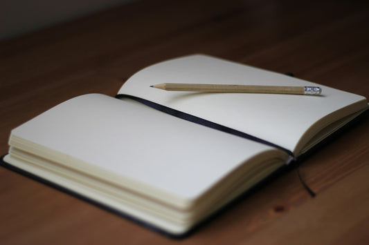 open blank journal with pencil